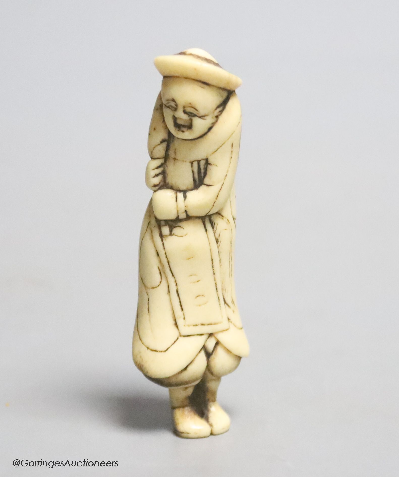 An 18th century Japanese stag antler netsuke of a Dutchman, 7cm